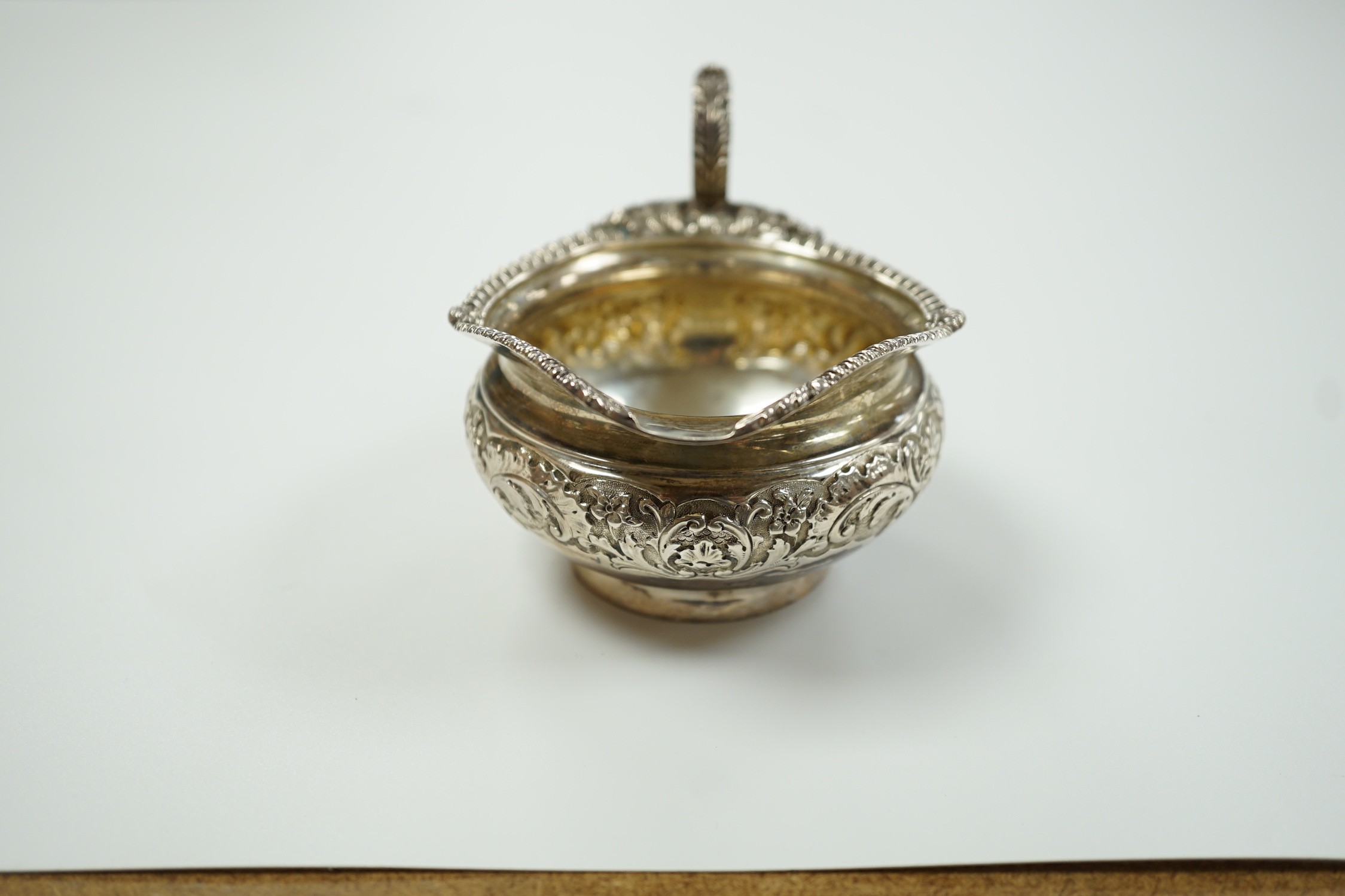 A late Victorian embossed squat silver cream jug, Edward Barnard & Sons, London, 1898, height 74mm, 4.6oz.